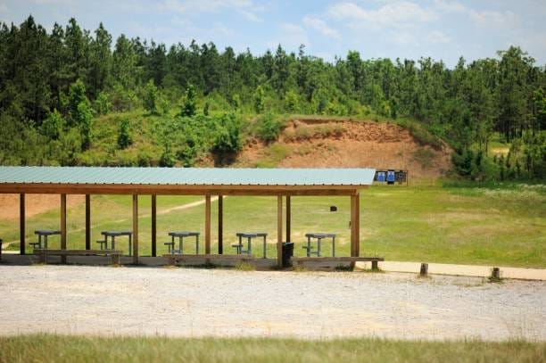 Shooting range in woods with pavilion and shooting tables and targets